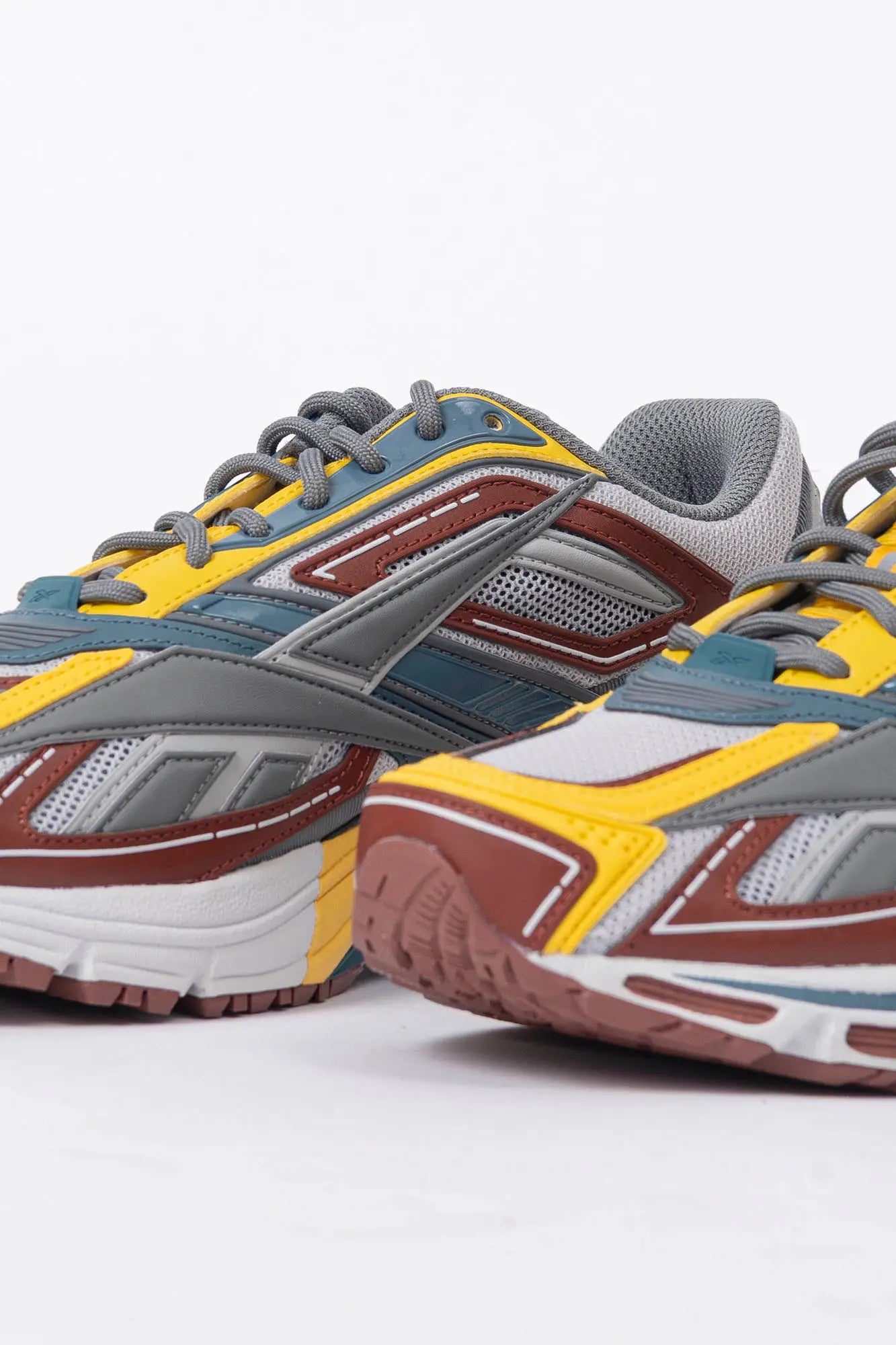Reebok, Mens Sneakers, Black, dual-density midsole with DMX cushioning technology, TPU midfoot Shank for Support, Rubber Outsole, Breathable Mesh, Leather Overlays, Tricolor Modern Technical Style Sneaker, Front 3/4 Close-up View. 