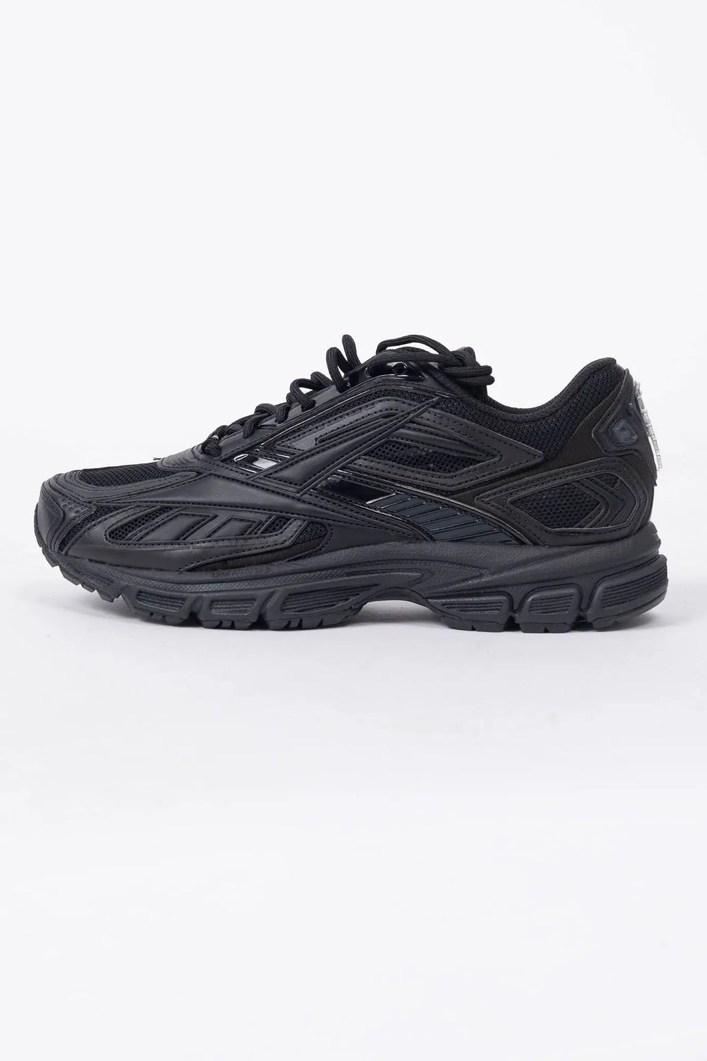 Reebok, Mens Sneakers, Black, dual-density midsole with DMX cushioning technology, TPU midfoot Shank for Support, Rubber Outsole, Breathable Mesh, Leather Overlays, All Black Modern Technical Style Sneaker, Side View. 