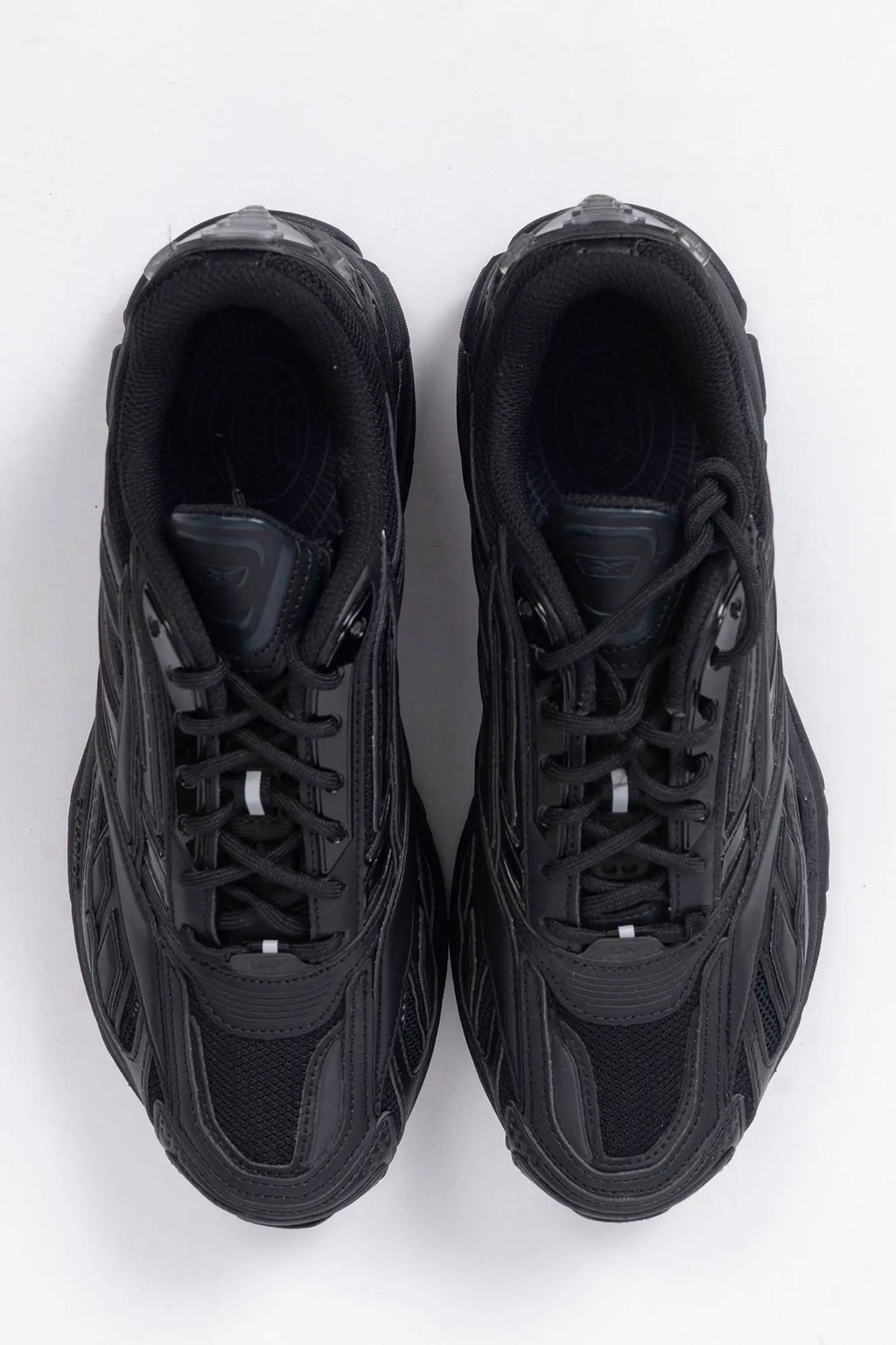 Reebok, Mens Sneakers, Black, dual-density midsole with DMX cushioning technology, TPU midfoot Shank for Support, Rubber Outsole, Breathable Mesh, Leather Overlays, All Black Modern Technical Style Sneaker, Top-Down View. 