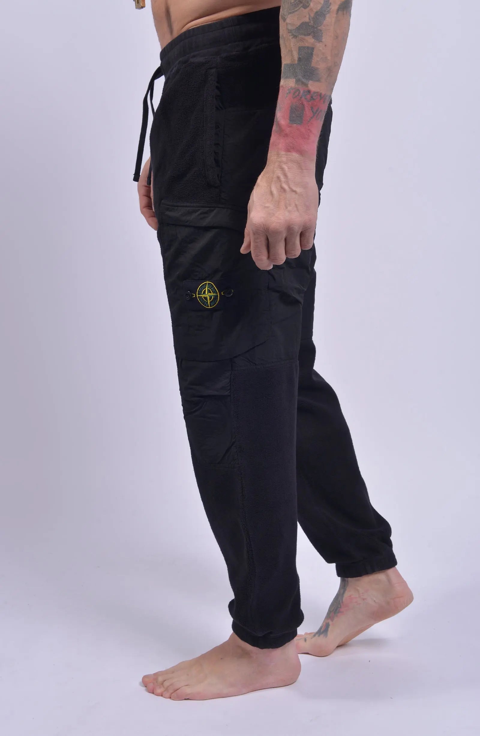 Stone Island, Mens Pants, Black V0029, Tattoos, Grenade tattoo, Drawstring, Elasticated Ankles, Compass Badge, Stone Island Badge, Side Pockets, Side Step Shot. 