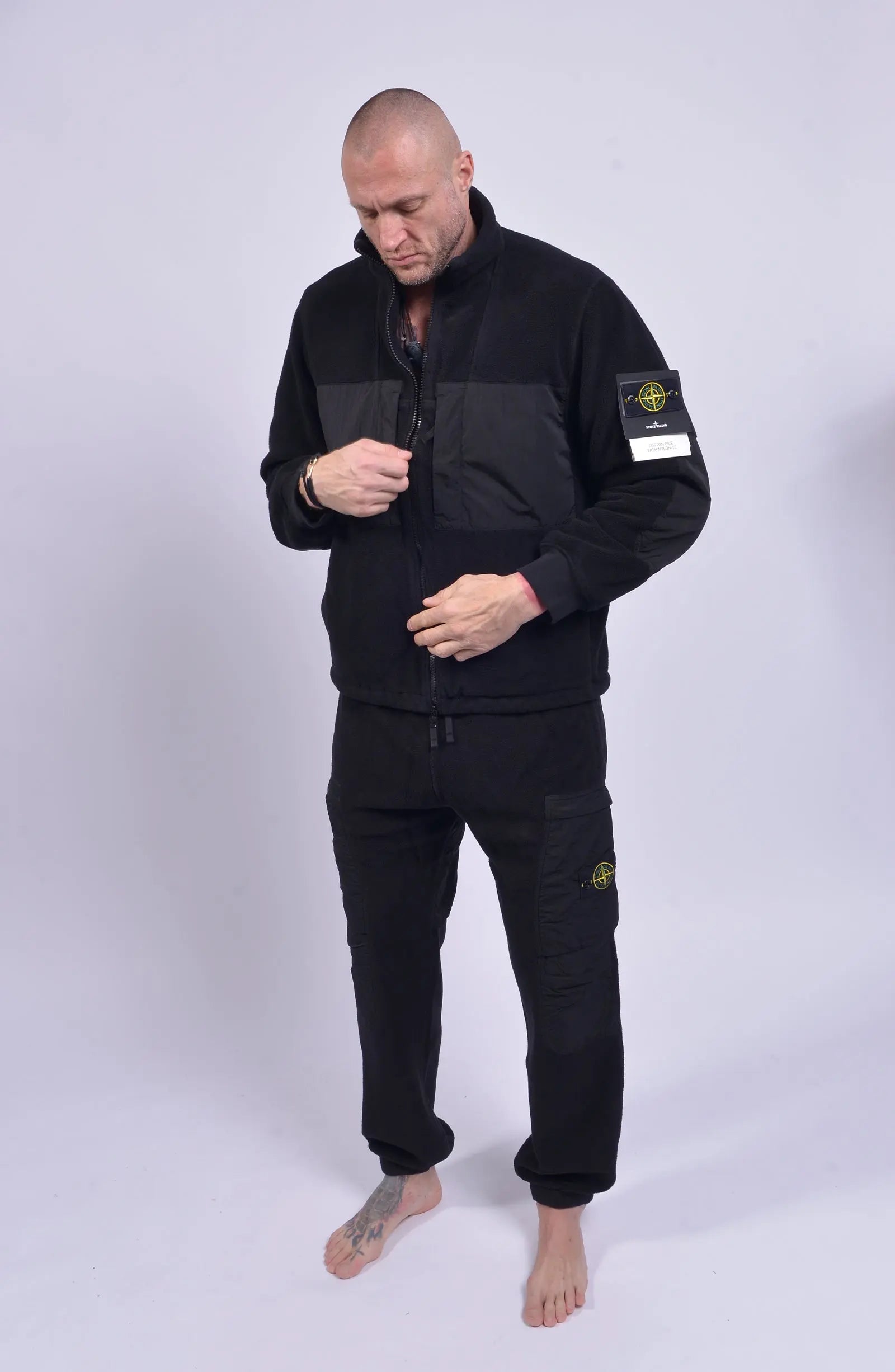 Stone Island, Mens Pants, Black V0029, Tattoos, Grenade tattoo, Drawstring, Elasticated Ankles, Compass Badge, Stone Island Badge, Side Pockets, in-motion Shot. 