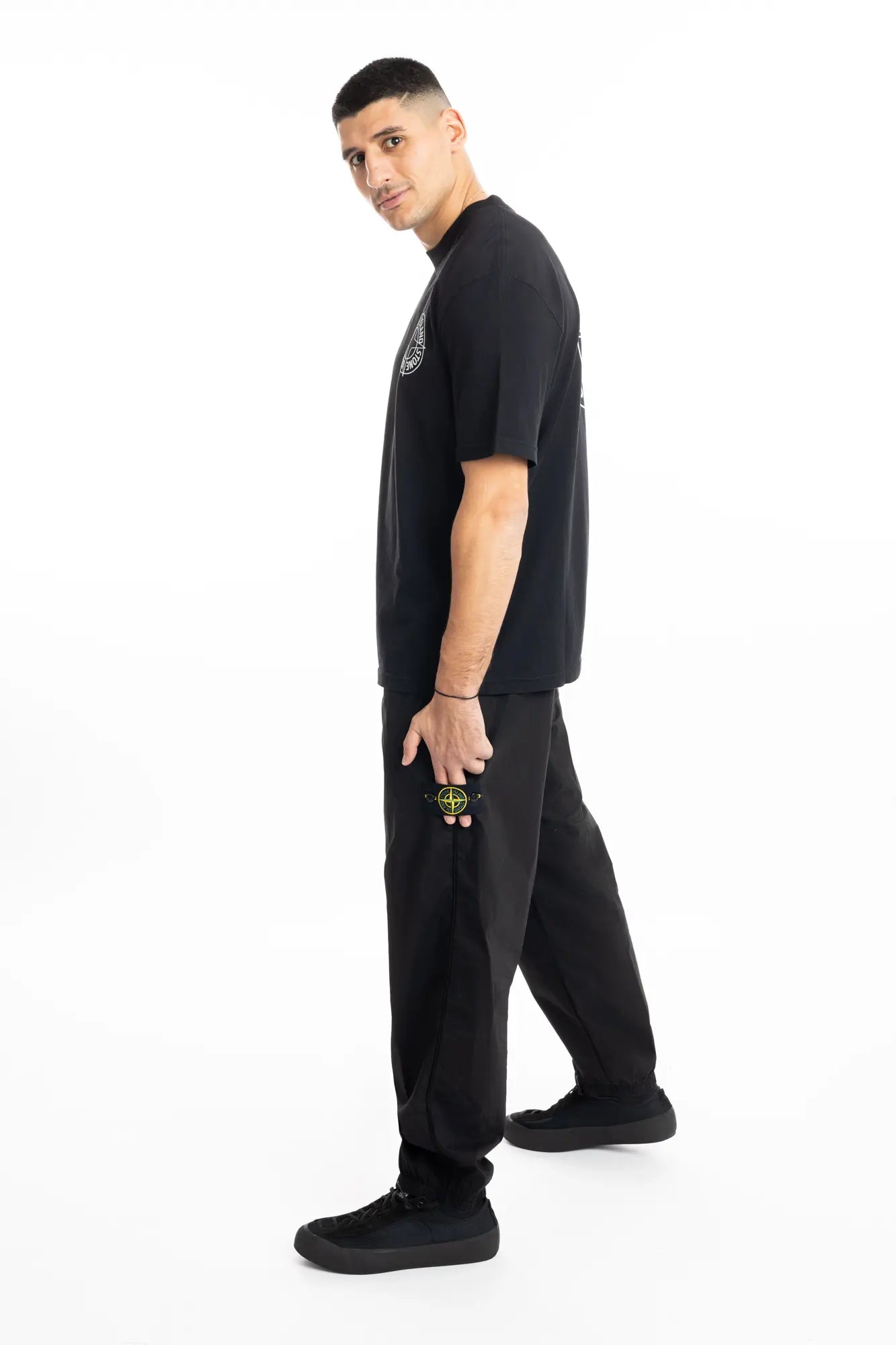 Stone Island, Mens Pants, Black, Elasticated cuffs and waistband, Compass badge, Zip Side Pockets, YKK Zippers, Full Body Side Photo. 