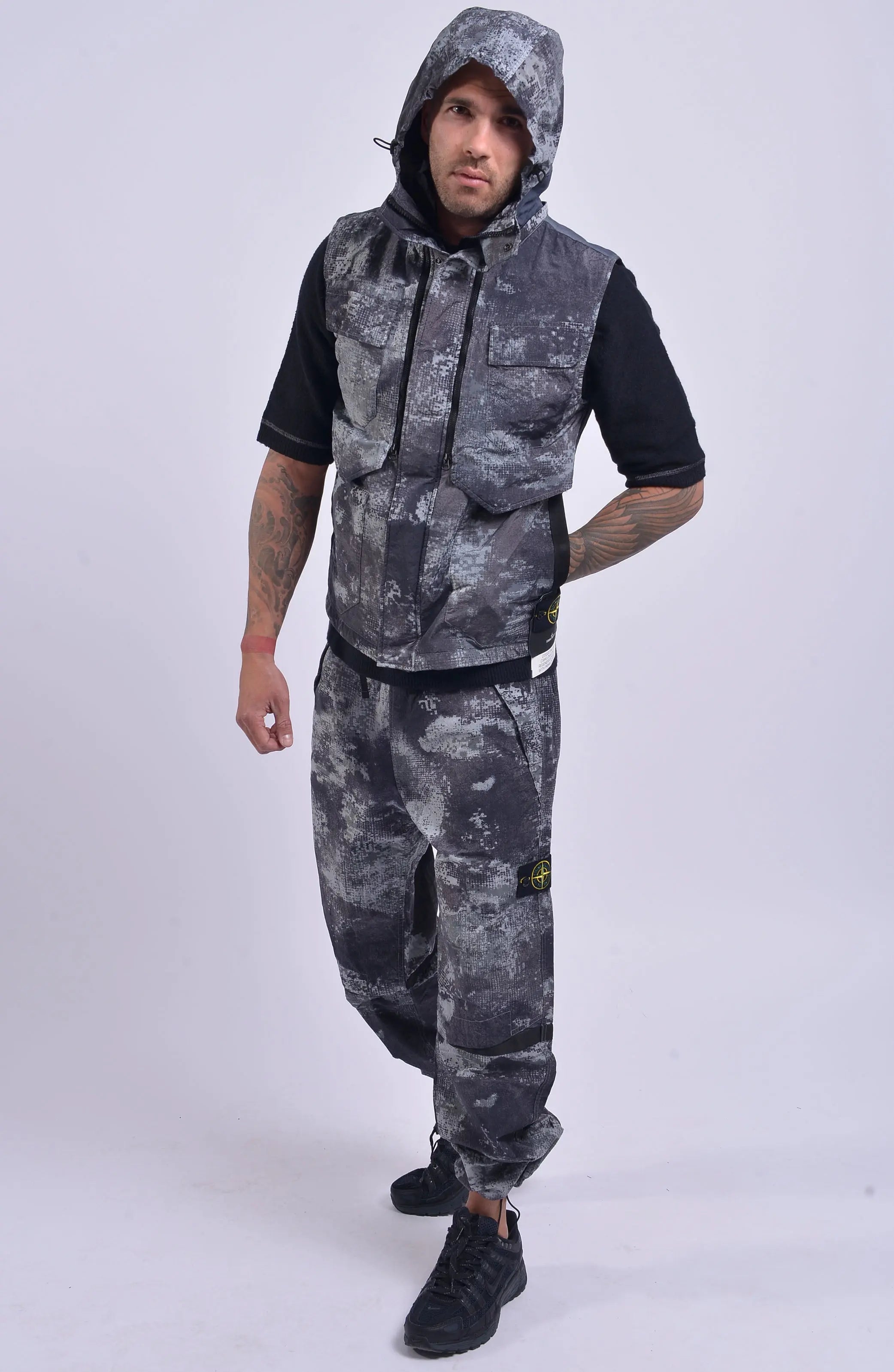 Stone Island, Mens Vest, Grey Dissolving Grid Camo, Regenerated Nylon Vest, Primaloft Padded, YKK Zippers, Velcro, Pockets, Stone Island Badge, Full Body Motion Photo. 