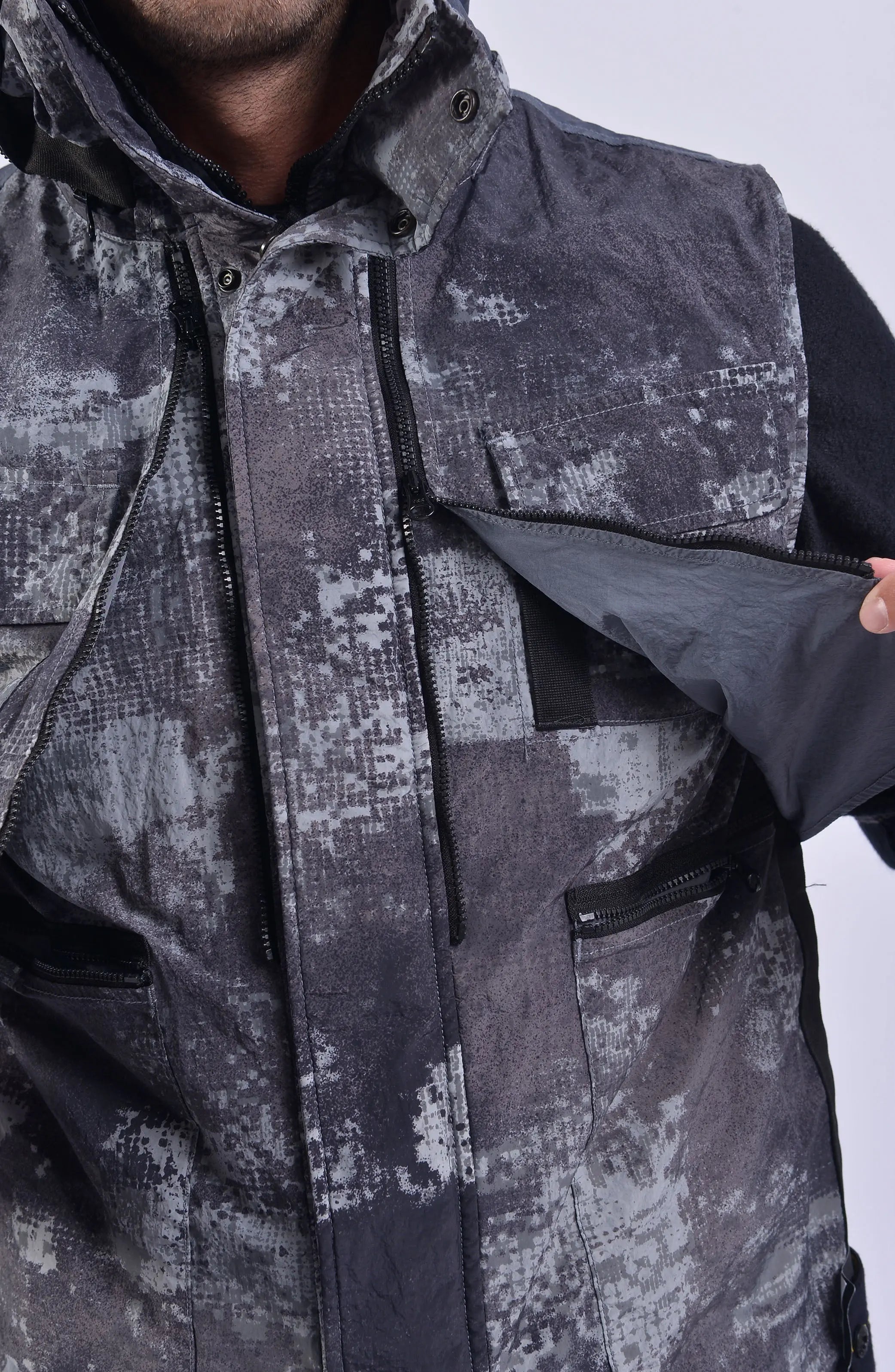 Stone Island, Mens Vest, Grey Dissolving Grid Camo, Regenerated Nylon Vest, Primaloft Padded, YKK Vislon Zippers, Velcro, Pockets, Hood, Stone Island Badge, Pocket Close-up Photo. 