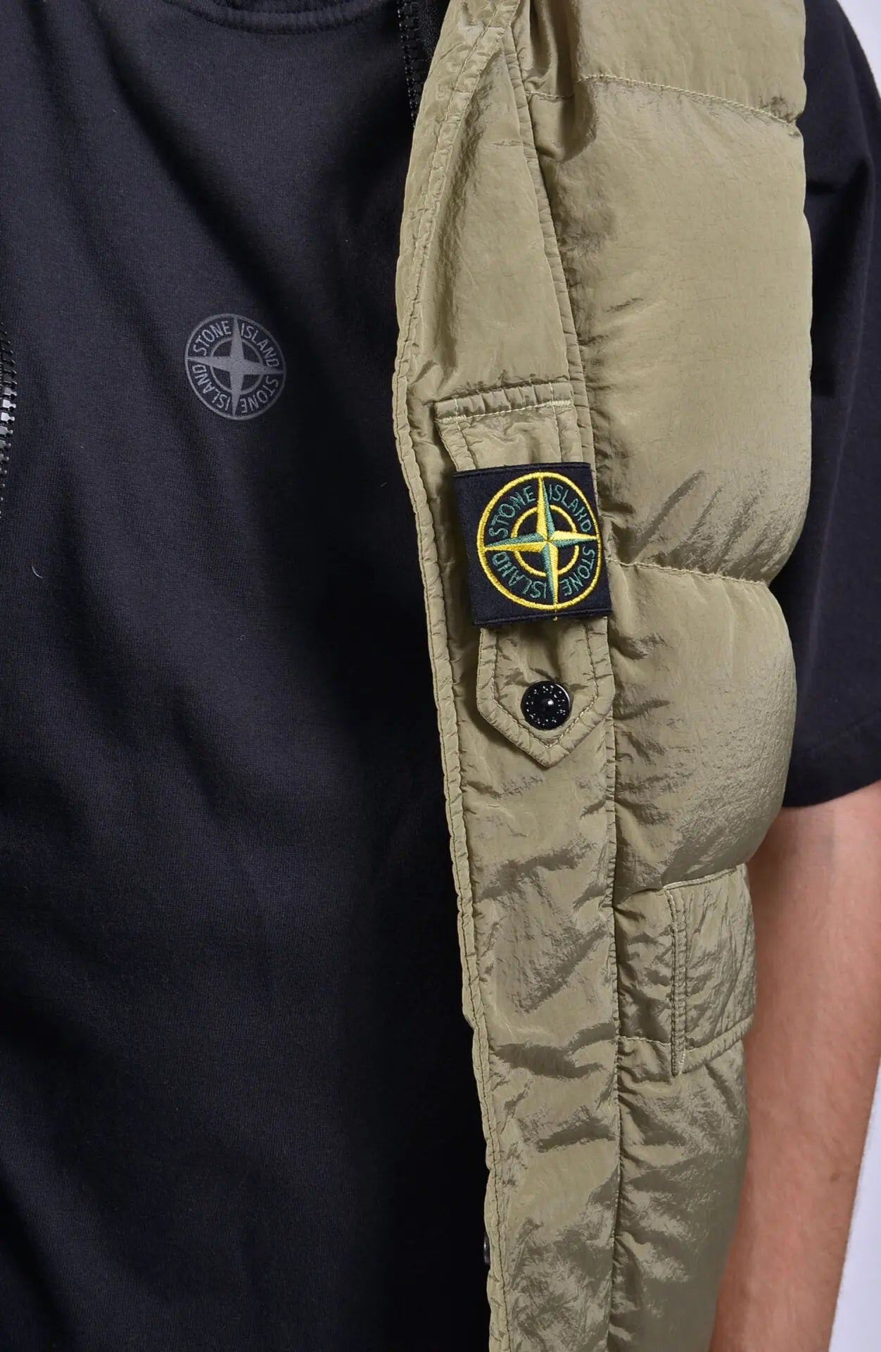 Stone Island, Mens Vest, Down Vest, Double-Faced Vest, Beige With Black Lining, Zippers, Stone Island Button, Pockets, Stone Island Badge, Close-up Photo. 