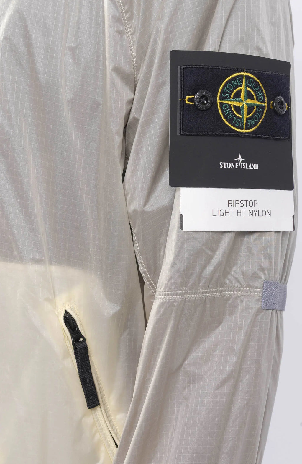 Stone Island, Mens Jacket, Windbreaker, Ivory White V0093, Semi-Transparent, Elasticated Cuffs, Full Zip, YKK Zippers, Compass Badge, Logo-Patch, Side Pockets, Hooded, Badge Close-up. 