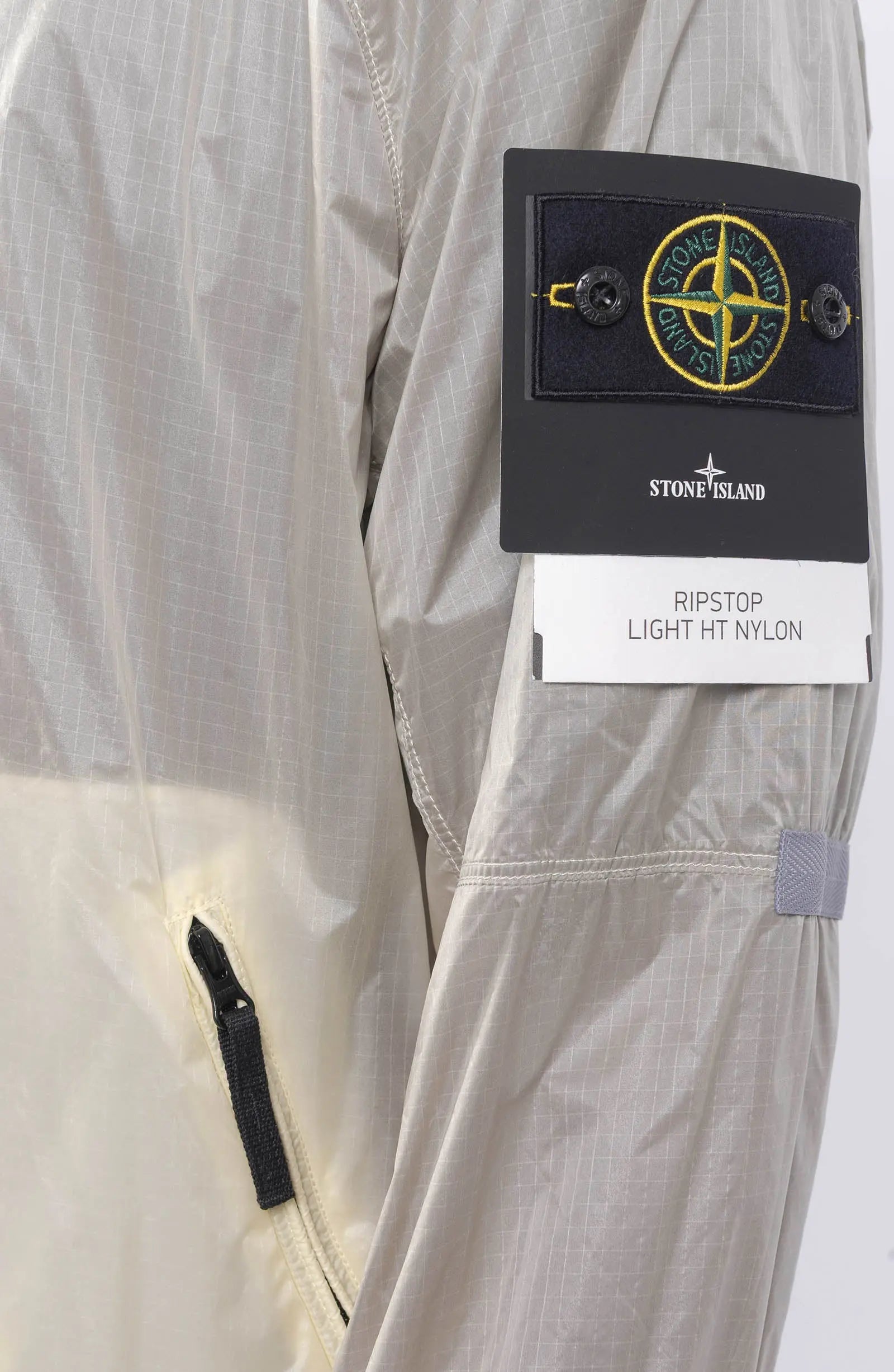 Stone Island, Mens Jacket, Windbreaker, Ivory White V0093, Semi-Transparent, Elasticated Cuffs, Full Zip, YKK Zippers, Compass Badge, Logo-Patch, Side Pockets, Hooded, Badge Close-up. 