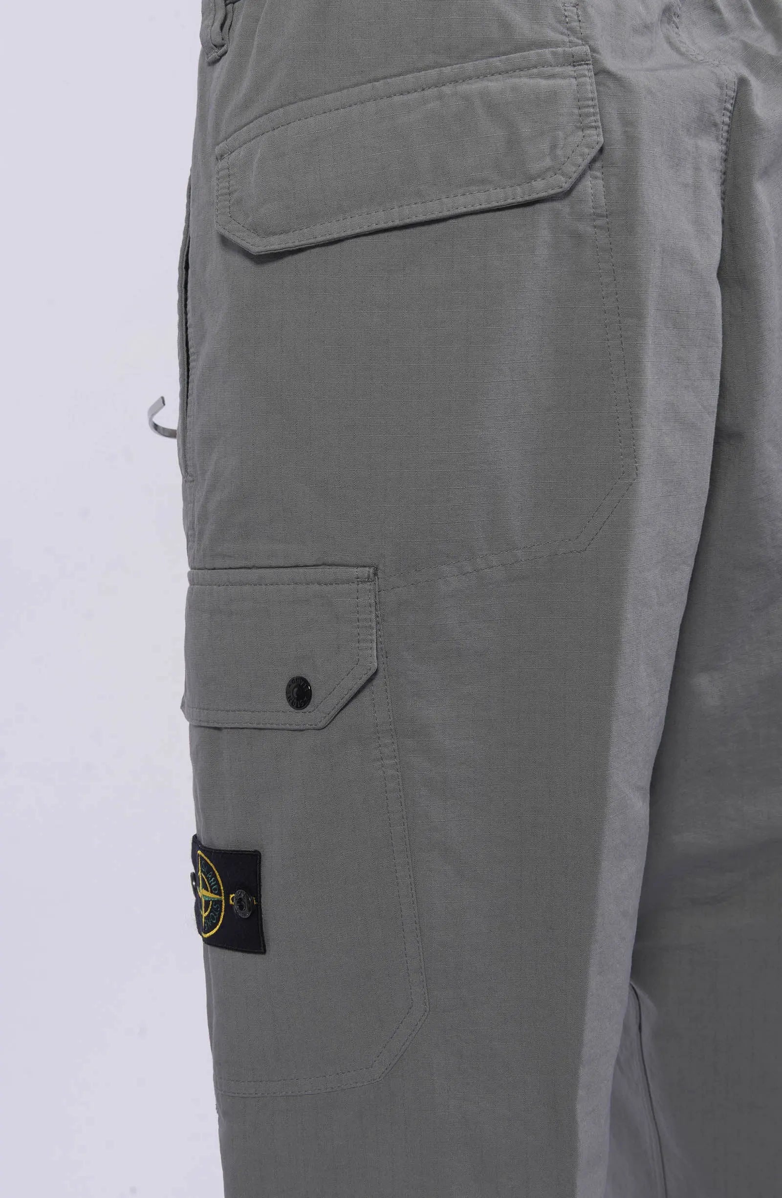 Stone Island, Mens Pants, Gray V0062, Cargo Pockets, Compass Badge, Logo-patch, Loose fit, Stone Island Button, Elasticated Cuffs, Side Pockets, Pockets Close-up. 