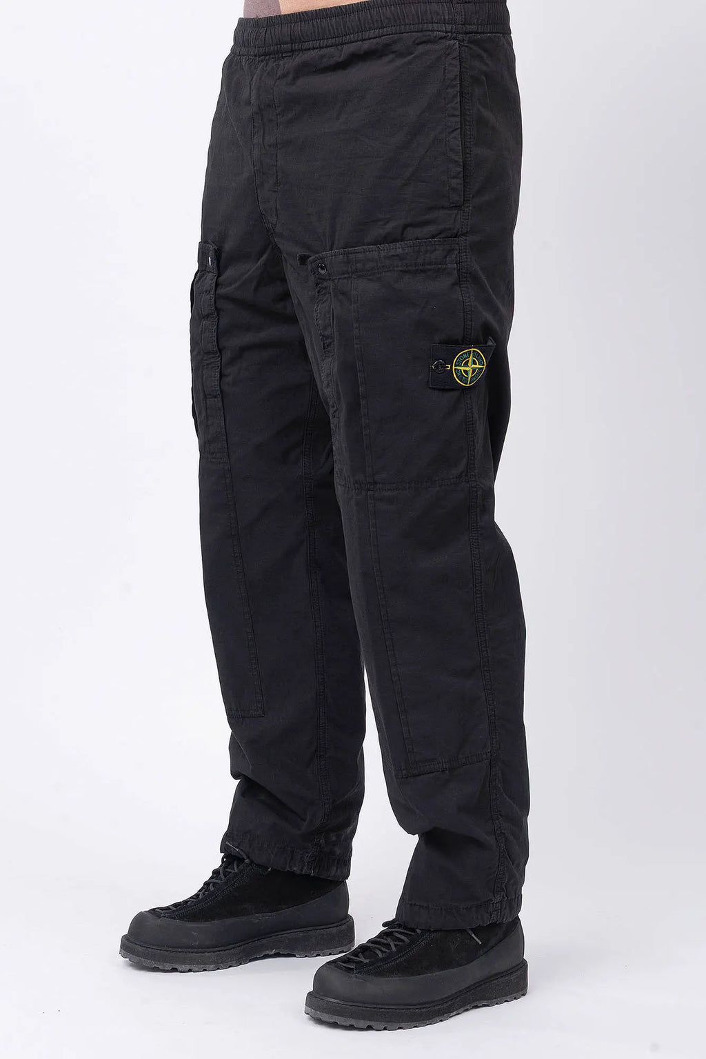 Stone Island, Mens Pants, Black V0029, Mens Trousers, Side Pockets, Welt Pockets, Snap Closure Pockets, Compass Badge, Logo-patch, Signature Side Badge, Elasticated Ankle Cuffs, Elasticated Waistband, Side Pockets, Back Pockets, Front 3/4 View. 