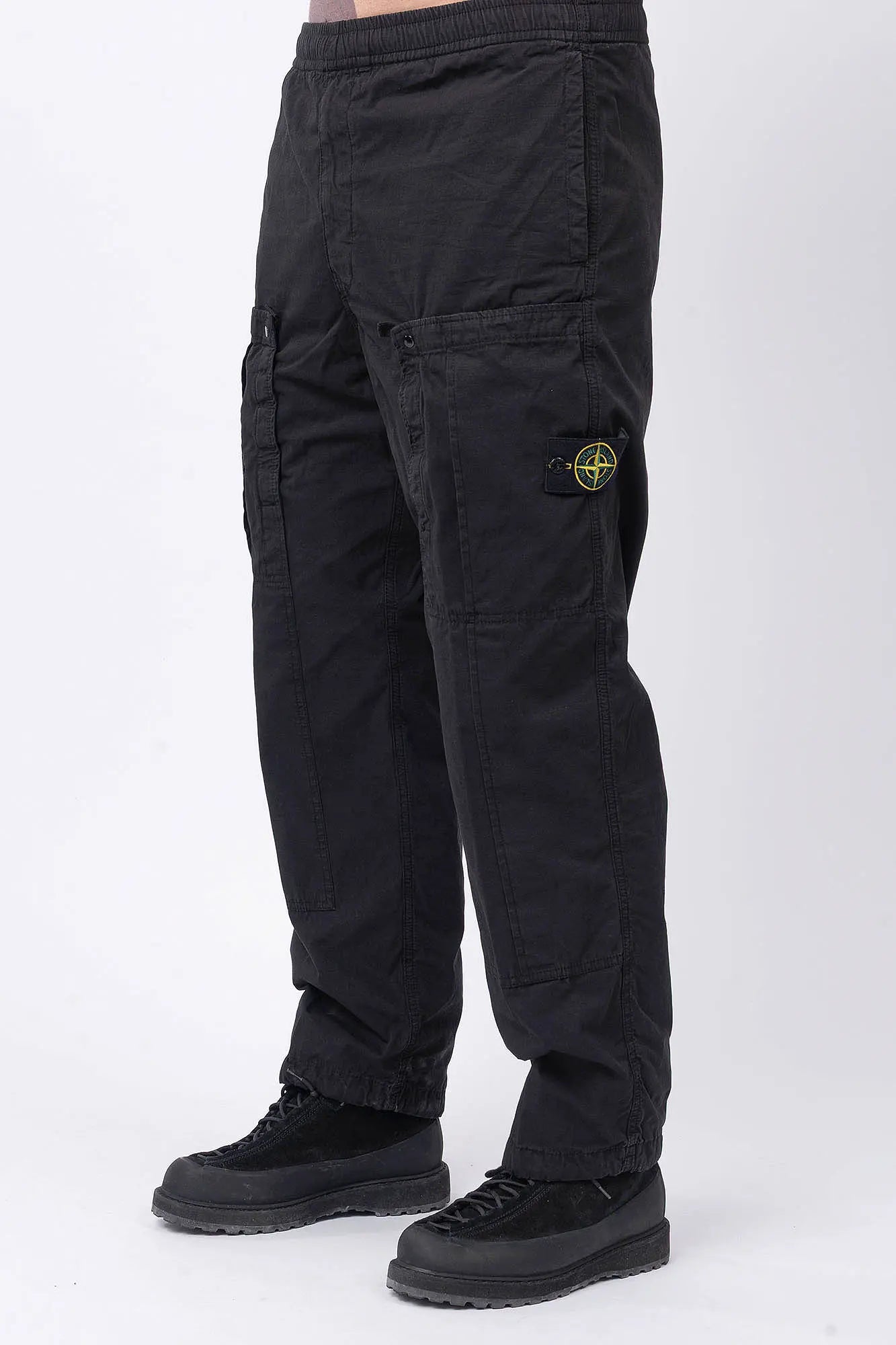 Stone Island, Mens Pants, Black V0029, Mens Trousers, Side Pockets, Welt Pockets, Snap Closure Pockets, Compass Badge, Logo-patch, Signature Side Badge, Elasticated Ankle Cuffs, Elasticated Waistband, Side Pockets, Back Pockets, Front 3/4 View. 
