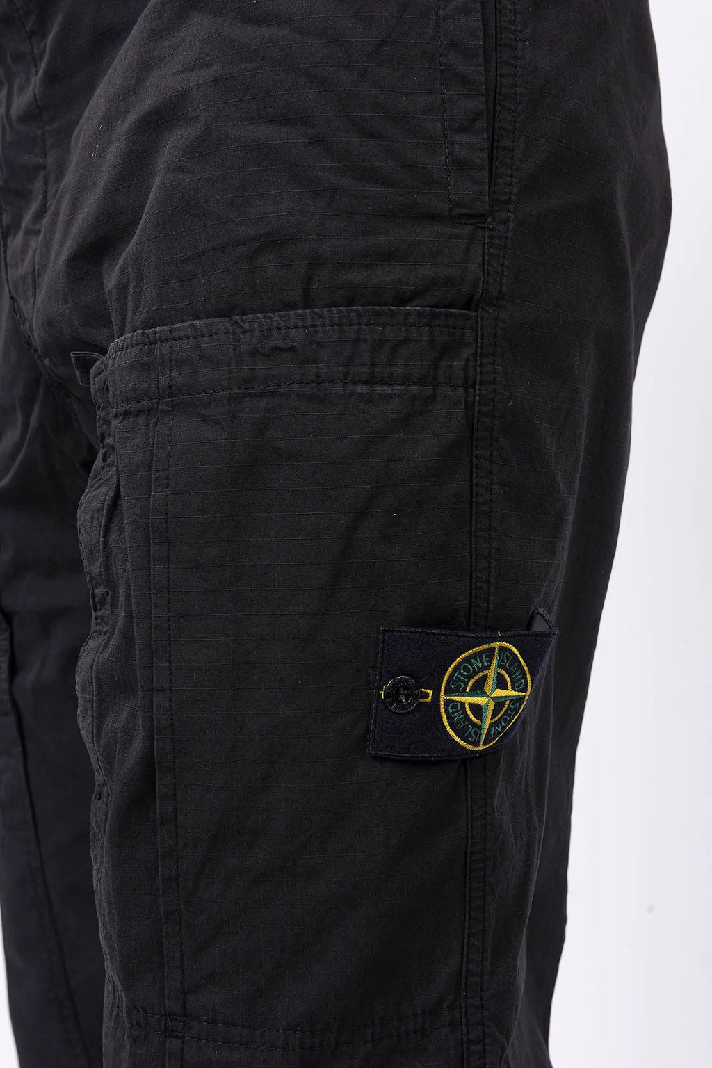 Stone Island, Mens Pants, Black V0029, Mens Trousers, Side Pockets, Welt Pockets, Snap Closure Pockets, Compass Badge, Logo-patch, Signature Side Badge, Elasticated Ankle Cuffs, Elasticated Waistband, Side Pockets, Back Pockets, Pockets and Badge Close-up. 