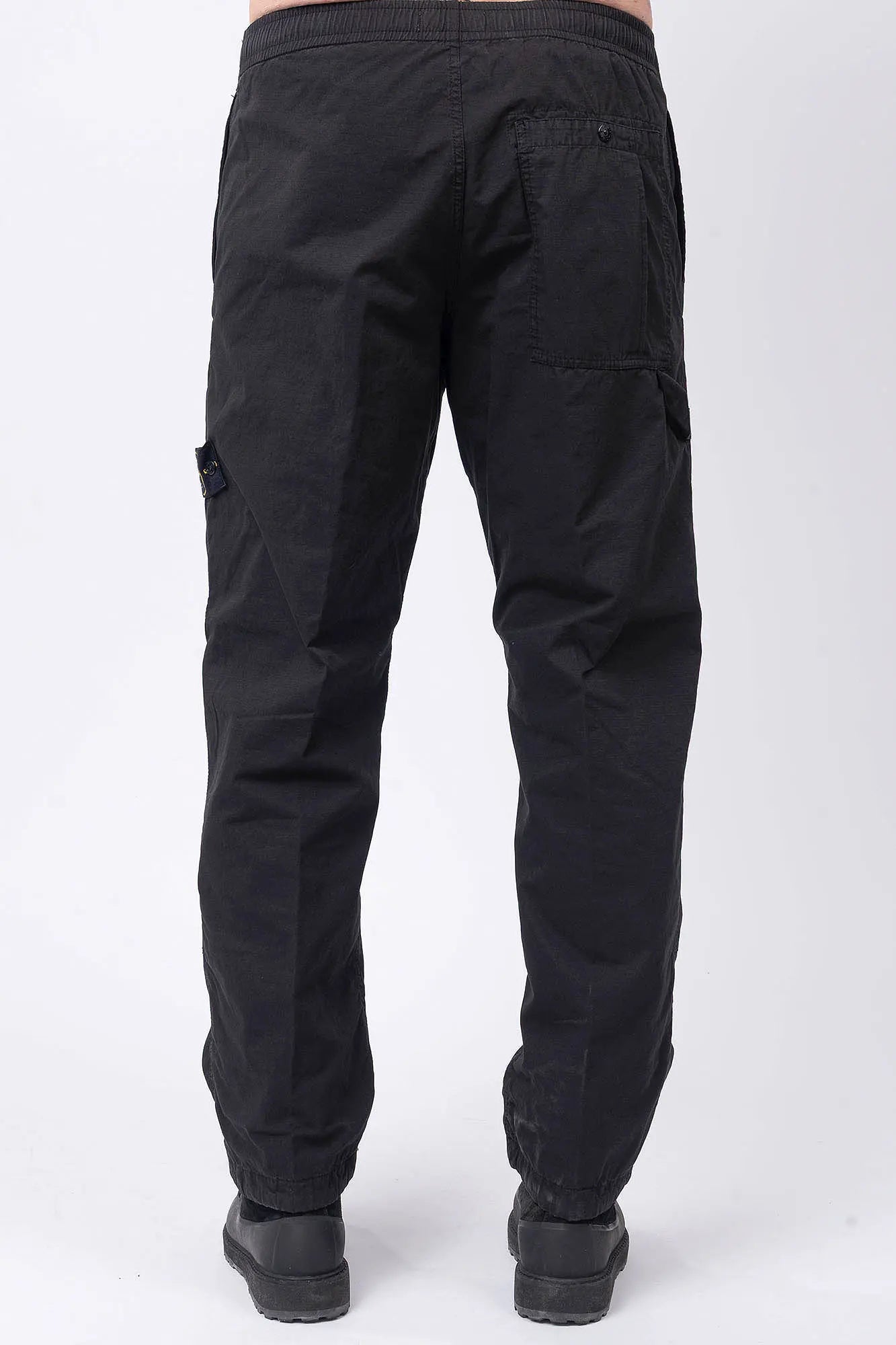 Stone Island, Mens Pants, Black V0029, Mens Trousers, Side Pockets, Welt Pockets, Snap Closure Pockets, Compass Badge, Logo-patch, Signature Side Badge, Elasticated Ankle Cuffs, Elasticated Waistband, Side Pockets, Back Pockets, Back View. 