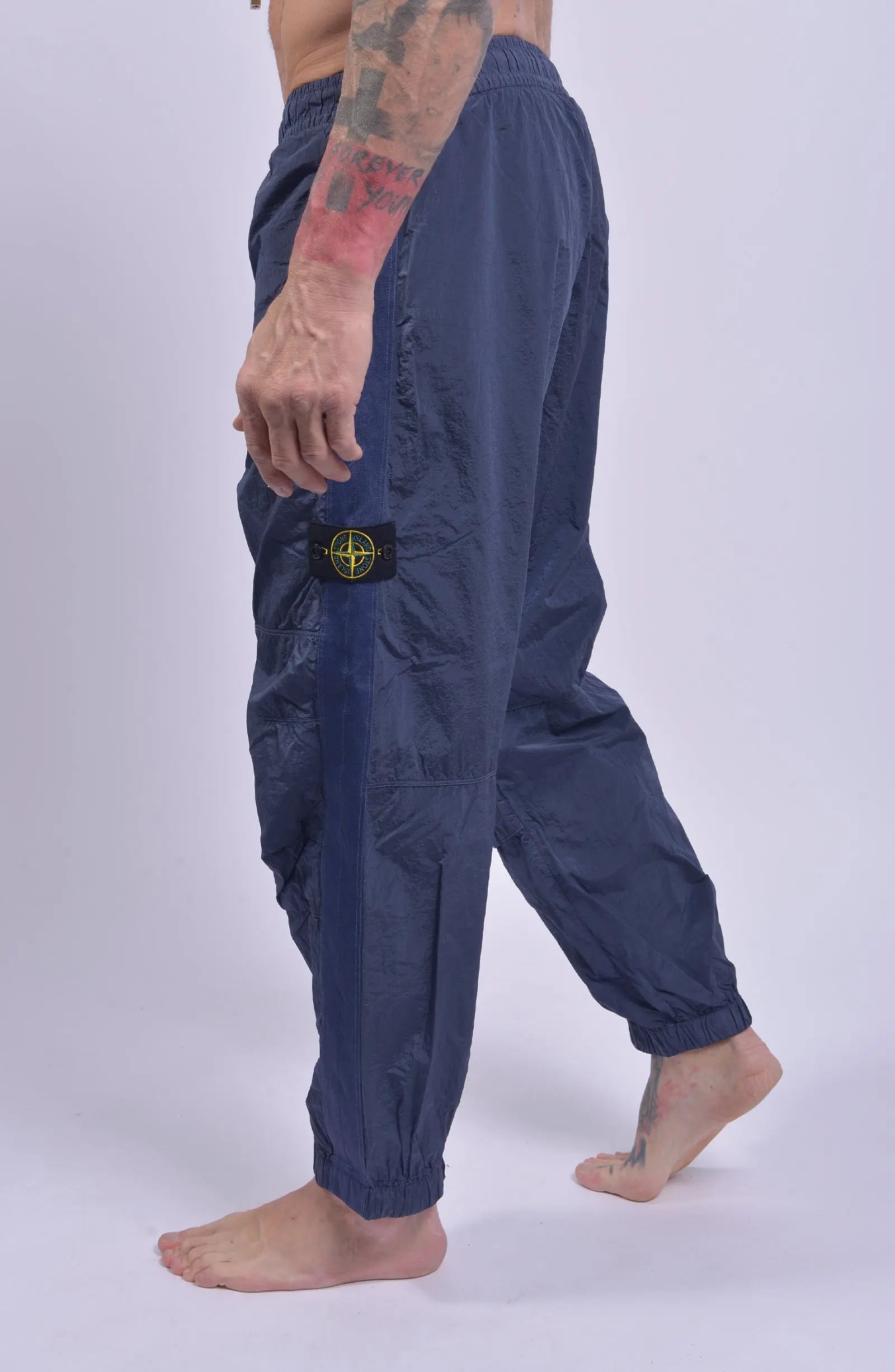Stone Island, Mens Pants, Pastel Blue V0046, Loose Fit Joggers, Elasticated waistband, Drawstrings, Side Pockets, Compass Badge, Elasticated Ankles, YKK Zippers, Side Step in-motion Photo. 