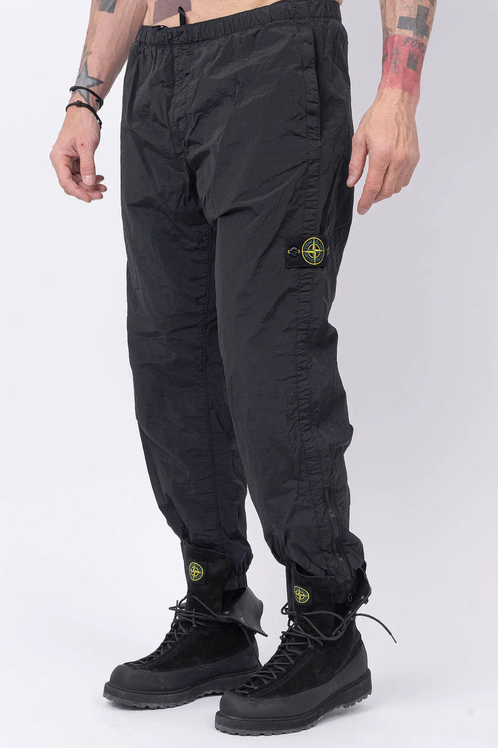 Stone Island, Mens Pants, Mens Trousers, Black V0029, Regular Fit, Tapered Legs, Side Pockets, Vertical Welt Pockets, Back Pockets, Elaticated Waistband, Drawstring Waist, Compass Badge, Logo-patch, Signature Side Badge, Front 3/4 View. 