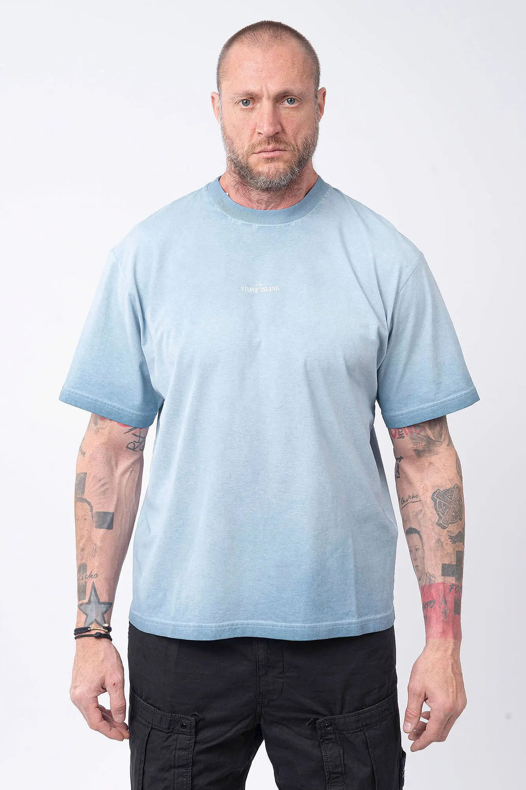 Stone Island, Mens T-Shirt, Dust Blue V004A, Uneven Cold Dyed, Front and Back Print, Wide Fit, Ribbed Hem, Ribbed Cuffs, Ribbed Neck, 100% Cotton, Organic Cotton, White Print, Graphic Back Print with Compass Logo, Logo-patch, Crew Neck, Round Neckline, Front Portrait. 