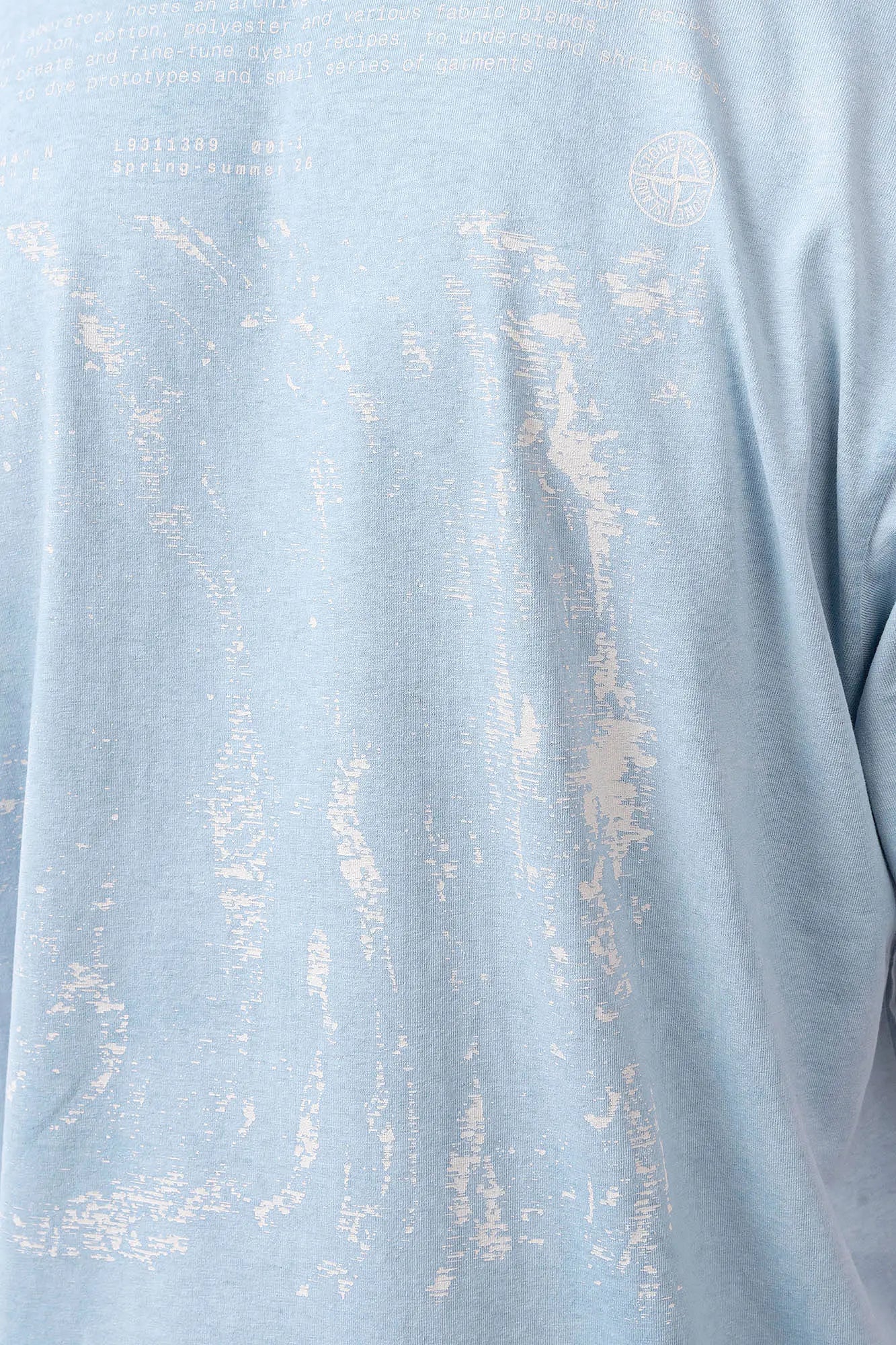 Stone Island, Mens T-Shirt, Dust Blue V004A, Uneven Cold Dyed, Front and Back Print, Wide Fit, Ribbed Hem, Ribbed Cuffs, Ribbed Neck, 100% Cotton, Organic Cotton, White Print, Graphic Back Print with Compass Logo, Logo-patch, Crew Neck, Round Neckline, Back Graphic Print Close-up. 