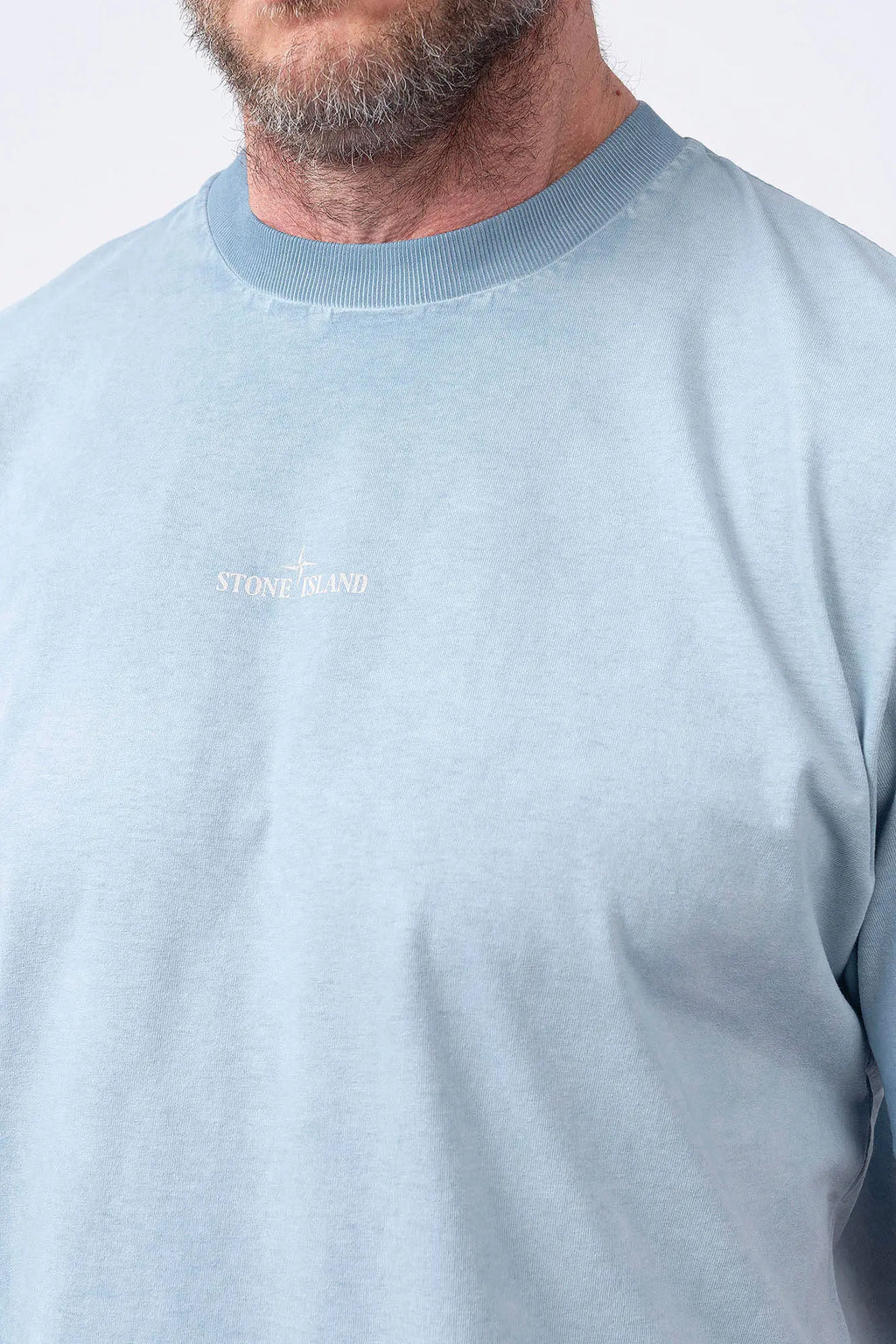 Stone Island, Mens T-Shirt, Dust Blue V004A, Uneven Cold Dyed, Front and Back Print, Wide Fit, Ribbed Hem, Ribbed Cuffs, Ribbed Neck, 100% Cotton, Organic Cotton, White Print, Graphic Back Print with Compass Logo, Logo-patch, Crew Neck, Round Neckline, Front Stone Island Logo Print Close-up. 