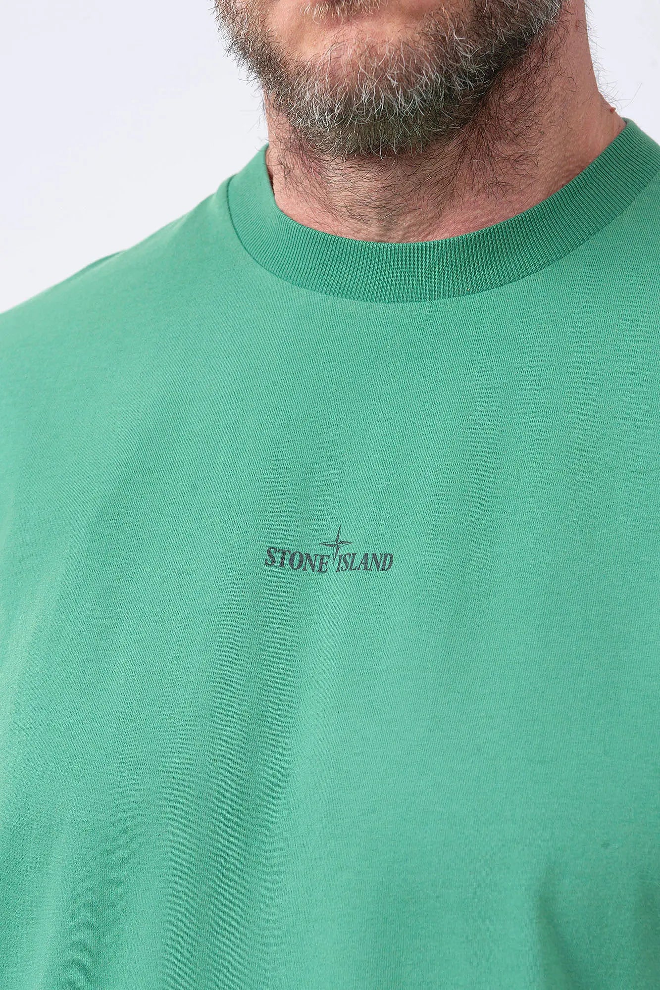 Stone Island, Mens T-Shirt, Malachite V005H, Green, Garment Dyed, Wide Fit, Short Sleeves, Ribbed Neck, Round Neck, Crewneck, Front and Back Print, Stone Island Print, Compass Print, Compass Badge, Logo-patch, Screen Print, Ribbed Hem and Sleeves, Front Print Close-up. 