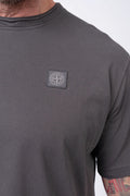 Stone Island, Mens T-Shirt, Charcoal V0165, Grey, Gray, Garment Dyed, Short Sleeves, Elastic Ribbing, Organic Cotton, Wide Fit, Raw-cut Neck, Crewneck, Round Neck, Compass Badge, Logo-patch, Chest Compass Patch, Compass Patch Close-up View. 