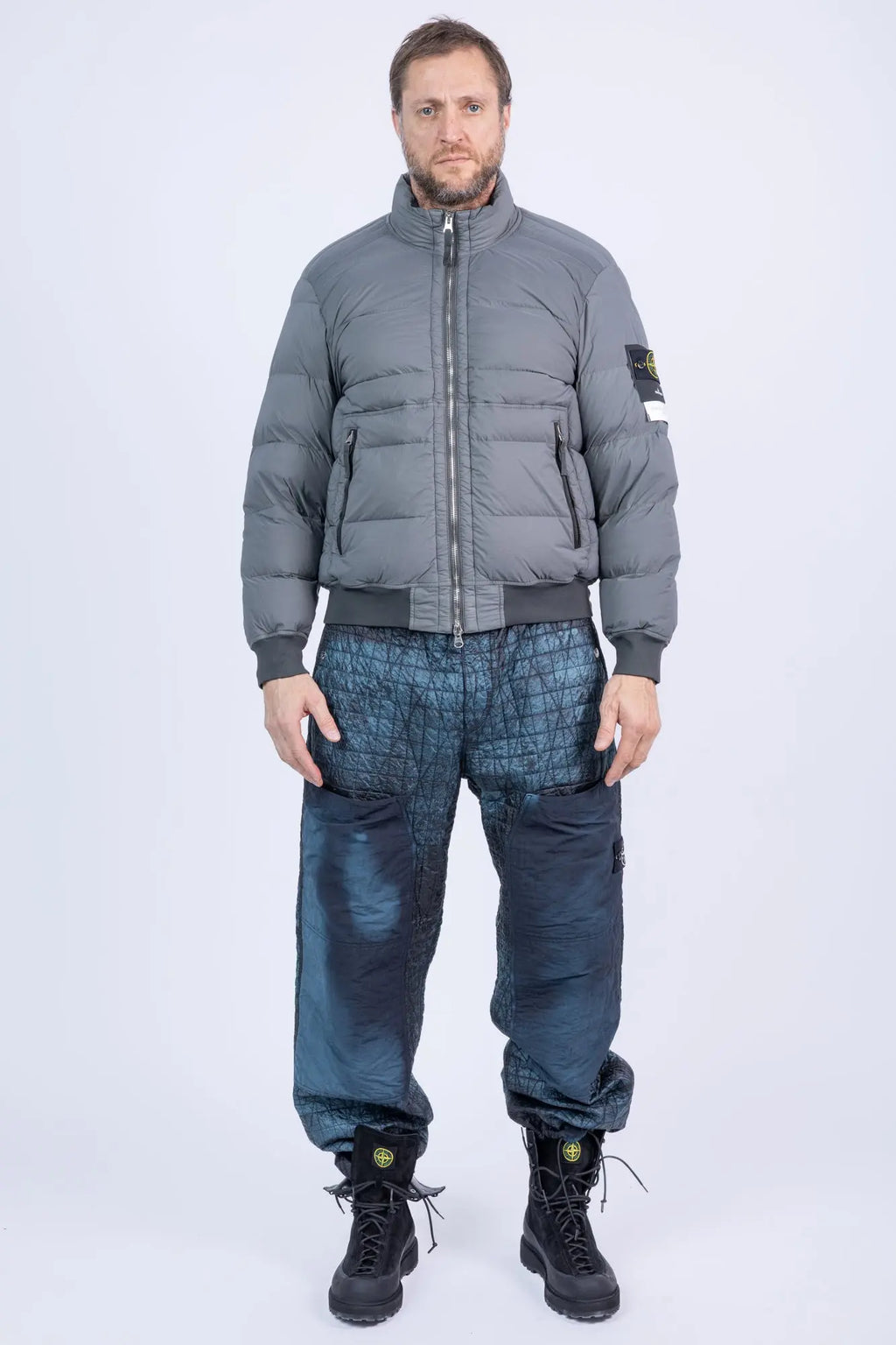 Stone Island, Mens Pants, Blue on Black V0029, Corrosion Treated, Compass Badge, Logo-patch, Limited Edition Stone Island Logo, Elasticated Cuffs, Side Pockets, Full Body Photo with Grey Stone Island Down Jacket. 