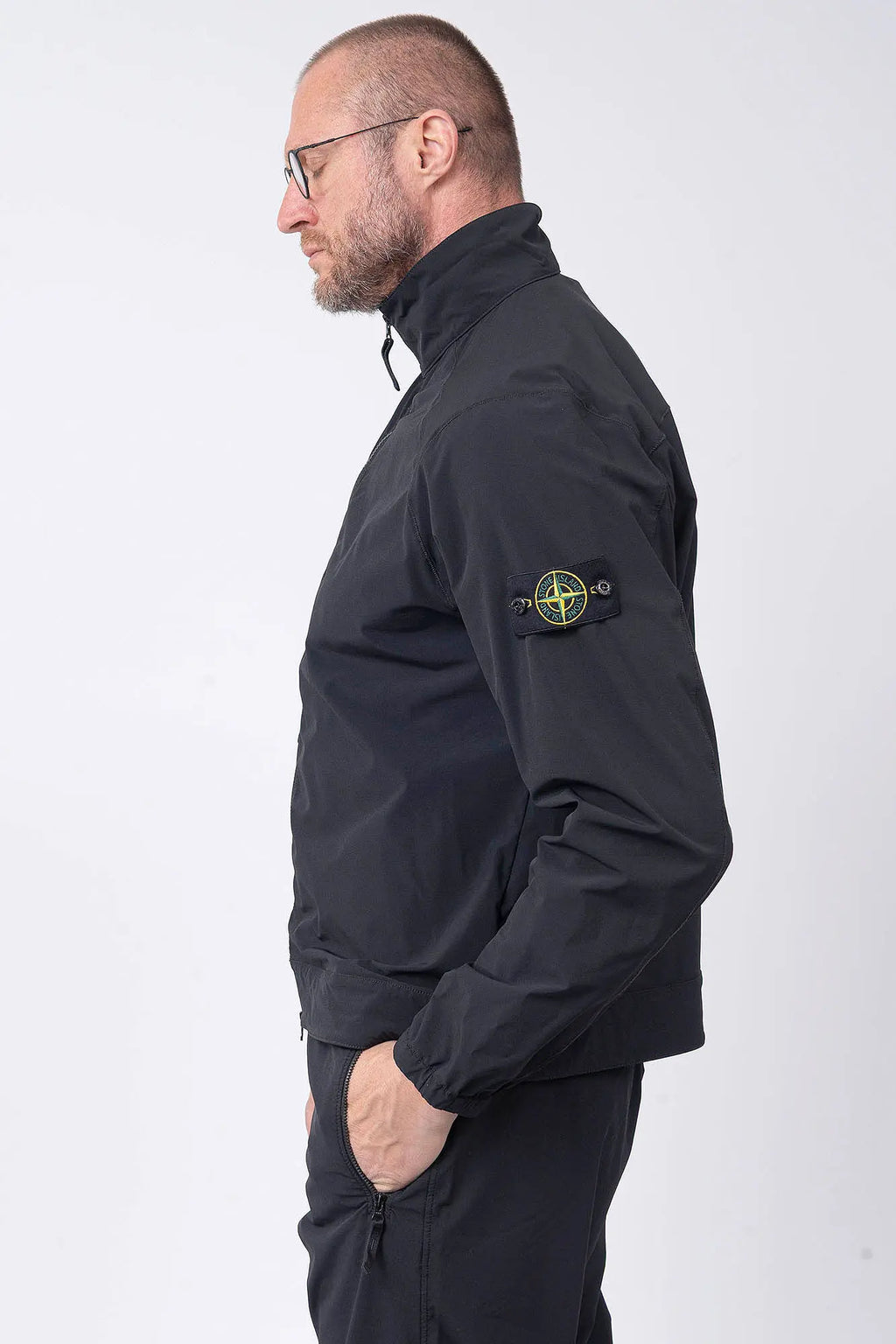 Stone Island, Mens Overshirt, Black V0029, Chest Zip Pocket, Side Compass Badge, Stretch Nylon tech fleece, Full-Zip, Centre Zip Closure, YKK Vilson Zippers, Elastic Cuffs, Side Badge View. 